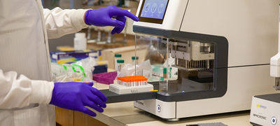 A technician processes COVID tests
